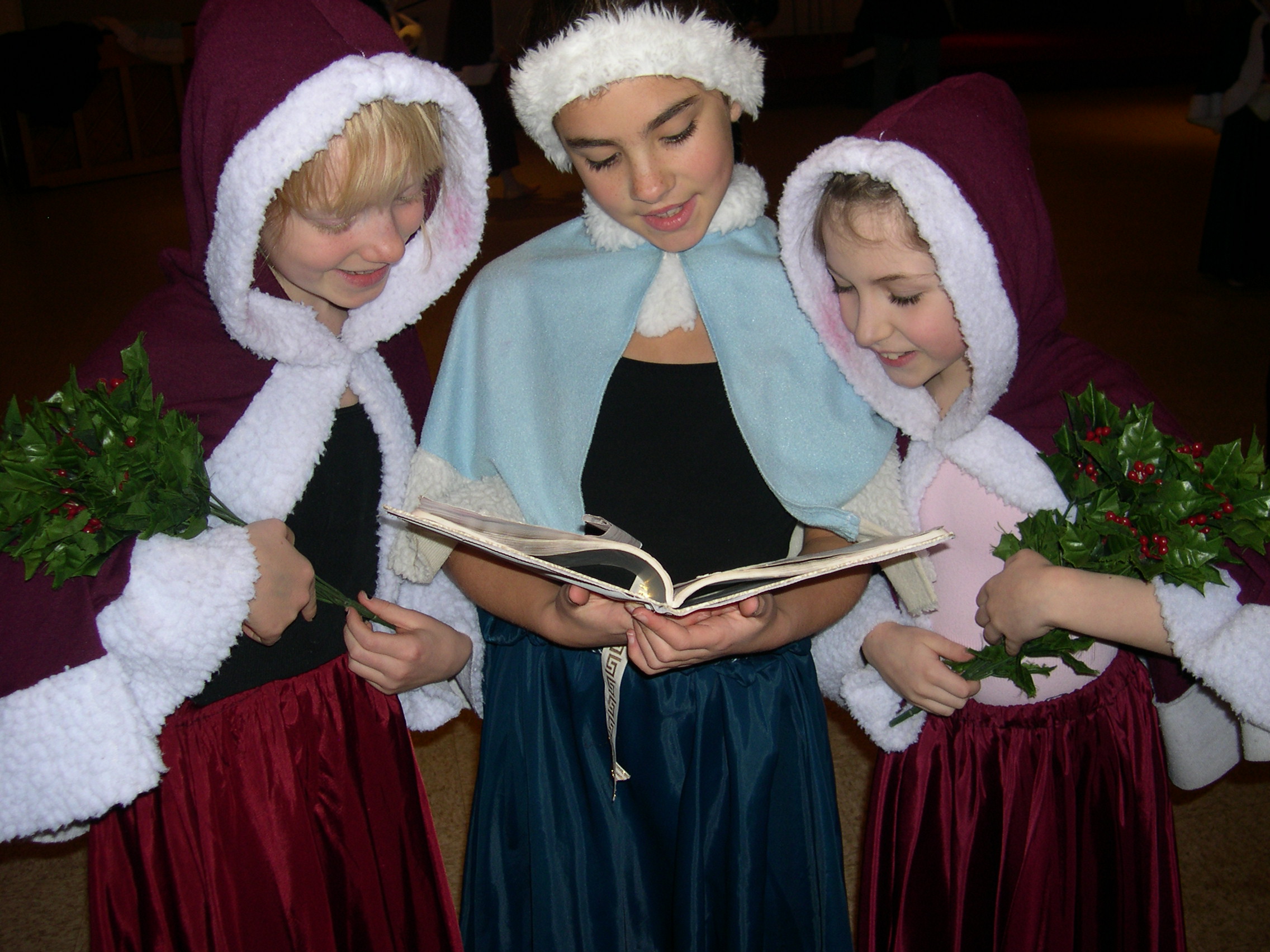 Three girls reading a book